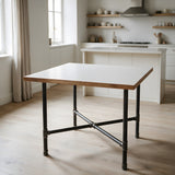 Base per tavolo da pranzo, ghisa e acciaio verniciato, a croce Ø 34 mm, in ambiente sotto un piano bianco opaco con bordo in legno